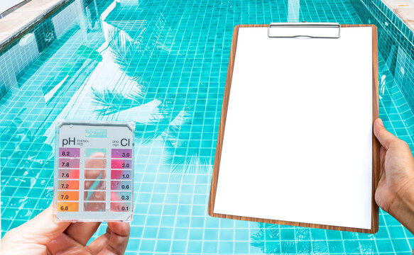 Water tester test kit with blank white paper over resort swimming pool background, quality water check, swimming pool maintenance and service