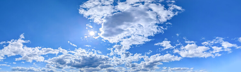 Obraz premium Wide detailed panorama of the sky with a large number of clouds. Spacious summer clear space with cloud flying towards the wind. Uniform filling with white spots of diagonal movement