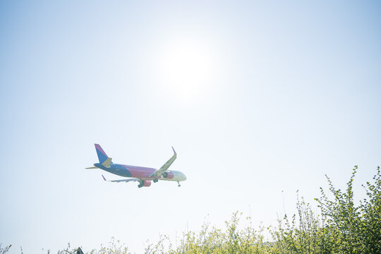 Bergamo, Italy - April 6, 2026: Dynamic shot of a commercial airplane landing at Orio al Serio Airport (BGY) in Bergamo, Italy, on a bright and sunny spring day