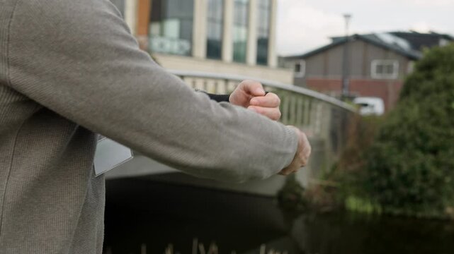 Office worker wearing a wrist brace for carpal tunnel syndrome, applying support for pain relief and protection outdoors