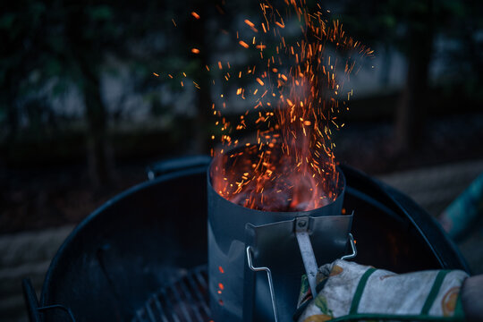 Close up on braces inside a BBQ ready to cook, sparks are visible.