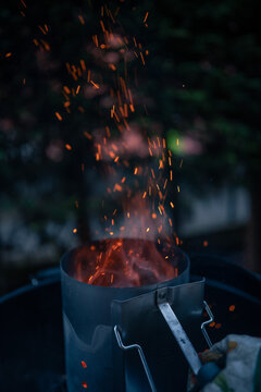 Close up on braces inside a BBQ ready to cook, sparks are visible.