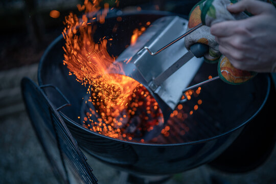 Close up on braces inside a BBQ ready to cook, sparks are visible.