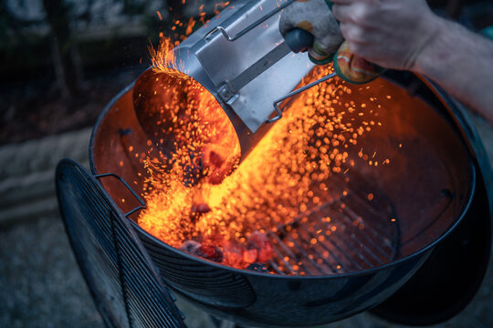 Close up on braces inside a BBQ ready to cook, sparks are visible.