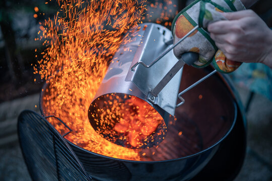 Close up on braces inside a BBQ ready to cook, sparks are visible.