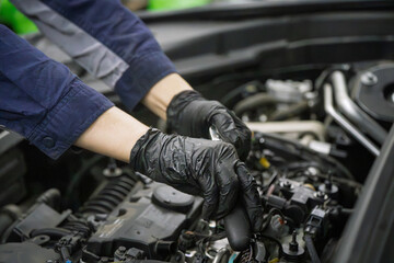 Fototapeta premium Mechanic Wearing Black Gloves Servicing Engine Bay