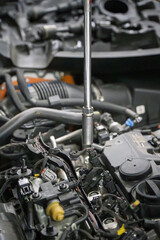 Fototapeta premium Close Up of Wrench Repair in Car Engine Bay