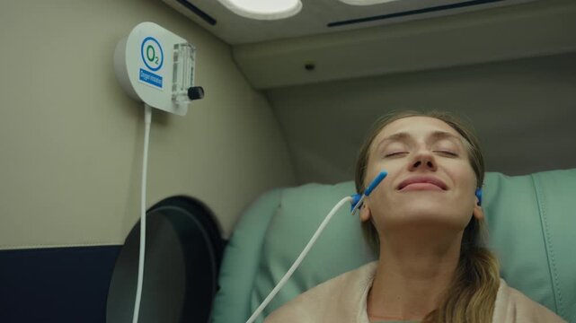 Woman doing hyperbaric oxygen therapy in a modern wellness clinic, embracing recovery, cellular regeneration, mental clarity, and biohacking trends for longevity, holistic health, and optimal performa