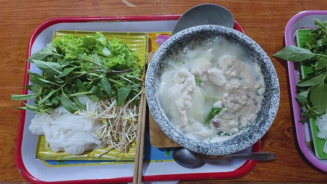 4K Close-up of Boiling Goat Stone Bowl Pho Experience in Buon Ho, Dak Lak Vietnam
the intense boiling broth in a traditional stone bowl, with steam rising and fresh ingredients ready to be added