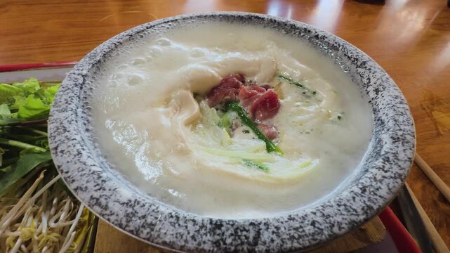 4K Close-up of Boiling Goat Stone Bowl Pho Experience in Buon Ho, Dak Lak Vietnam
the intense boiling broth in a traditional stone bowl, with steam rising and fresh ingredients ready to be added
