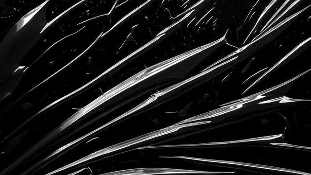 transparent plastic film wrap overlay texture on black background stop motion