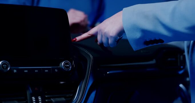 Close up of hand pointing at a gap in a black automotive dashboard during a quality control inspection