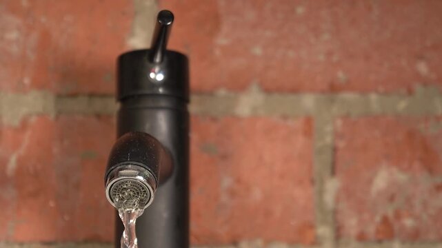 Red brick. Water tap. Slow motion. High quality 4k footage