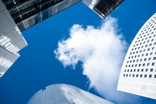 Corporate business finance buildings form a modern skyline as architecture emphasizes geometry and perspective at La Defense Paris with glass office district towers