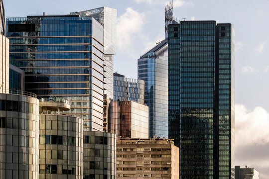 Glass towers and skyscrapers define a modern skyline with corporate office architecture in La Defense Paris creating a business finance district scene