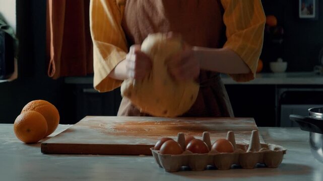 Woman in apron mixing raisin dough for Easter bread in home kitchen