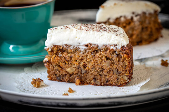 Carrot cake with almond flour and walnuts, topped with whipped cream. Gluten-free.
