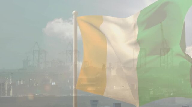 Wind gusts lifting vertical tricolor flag, fabric billowing rightward, showing breezy port weather