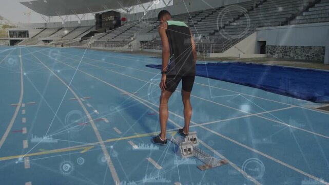 Sprinter walking blocks, stepping into crouch while sports HUD tracking watch, preparing to sprint