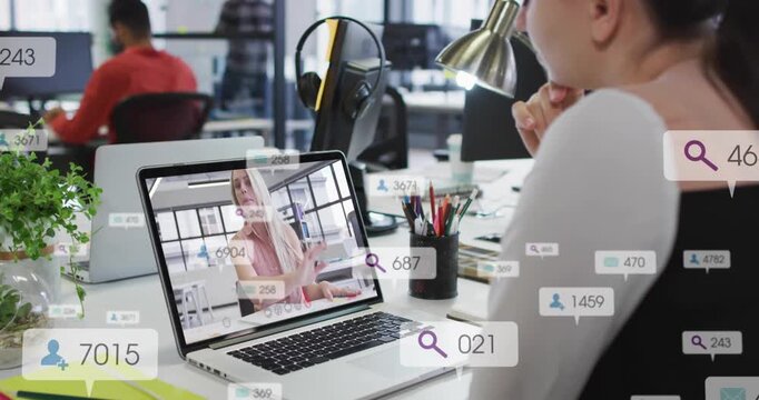 Seated woman viewing laptop call in marketing host speaking causing user icons and metrics rising