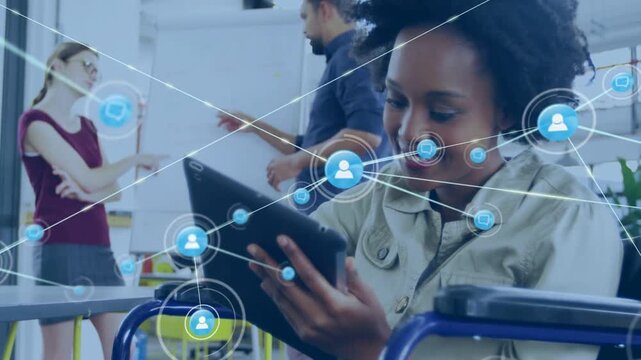 Woman seated in wheelchair tapping tablet, causing network overlay expanding and showing tech links