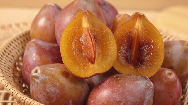 Fresh prunes in a basket.