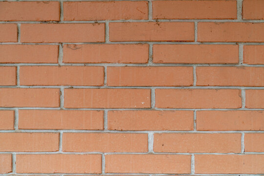 Orange brick wall texture with clean horizontal pattern and uniform layout, architectural background with minimal composition