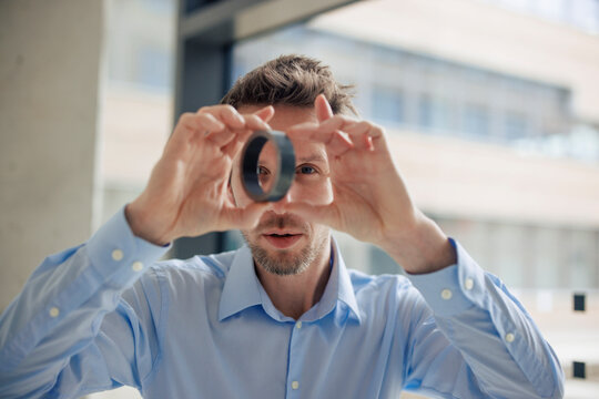 Engineer examining round metal object at workshop