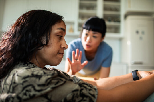 Two women arguing in a home kitchen
