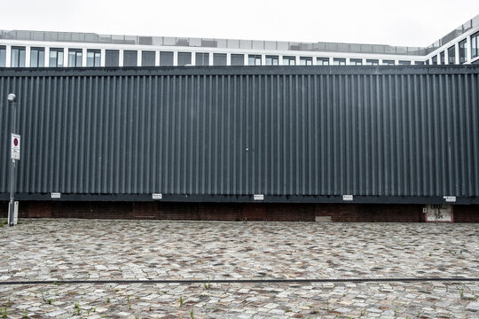 Modern industrial container building facade in an urban courtyard with minimalist lines and empty space for clean abstract background