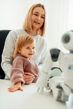 Child and doctor interacting with robot in pediatric hospital