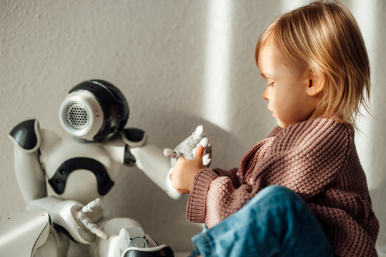 Child interacting with robot in healthcare and technology concept