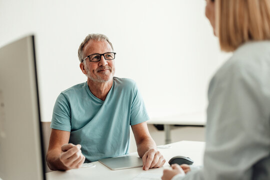 Patient and doctor talk during consultation at the hospital clinic