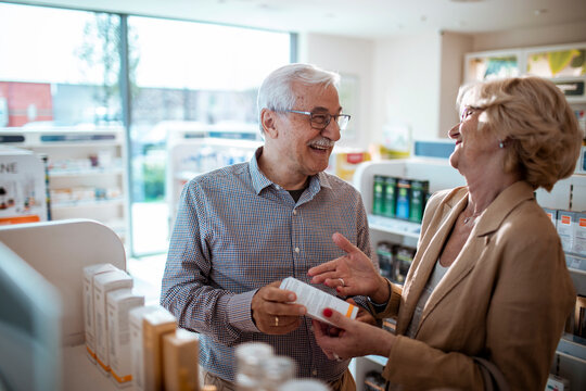 Senior couple shopping for vitamins at pharmacy