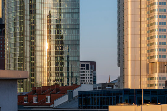 City rooftop view toward Frankfurt Germany Bankenviertel skyline where modern glass office skyscraper forms vertical pattern in evening light