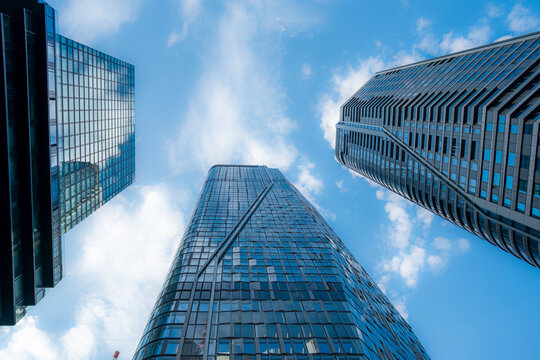 Modern glass office skyscraper architecture rises in Frankfurt Germany Bankenviertel seen from street level perspective with open sky above
