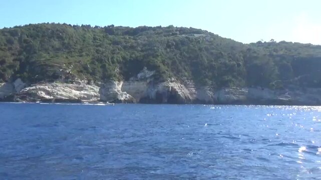 Greek islands of Paxos Antipaxos. Boat trip around the Mediterranean Sea by ship with a stop in mysterious caves. Fantastic view of the sea and mountains