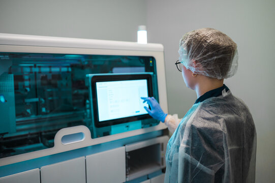 Lab Tech Manages Instruments. Diligent Laboratory Professional Oversees Diagnostic Tools Precisely