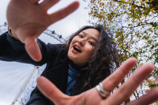 Smiling woman with curly hair enjoying urban outdoor travel