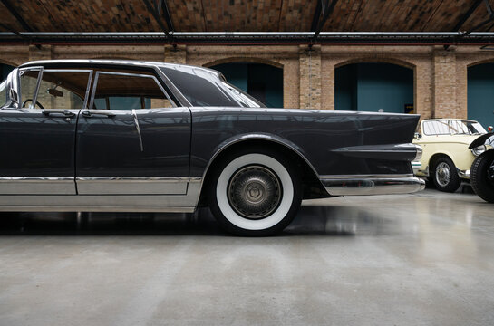 Side profile detail of Facel Vega Excellence. Rare 1950s french sedan with whitewall tires, tailfins and chrome detailing, parked in Classic Remise Berlin, Germany - January 14 2026.