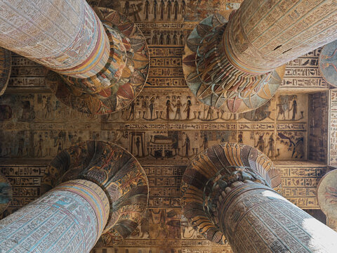 Upward view of painted columns and decorated ceiling at the Temple of Khnum in Esna Egypt