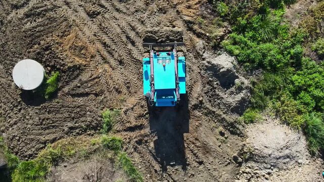 Aerial top down view of a mini dumper leveling ground
