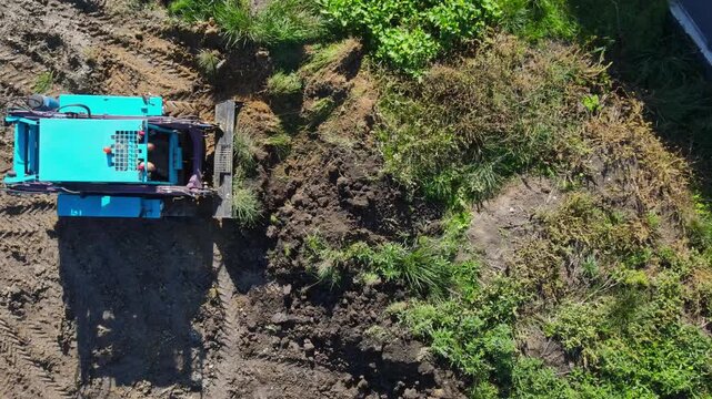 Aerial view of compact track loader leveling ground