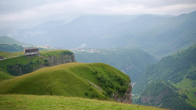 Scenic view of deep canyon and green mountains in Caucasus, Georgia near Kazbegi. Majestic cliffs over Aragvi river valley, wilderness landscape, travel discovery and eco tourism concept, highlands
