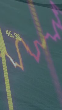 Vertical video: On pullback coastal wave pulsing while gold spike rising, 50