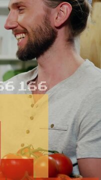 Vertical video: Man holding tomatoes, pan sparking food bars and numbers over chest showing data