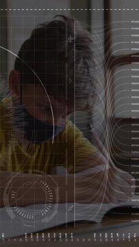 Boy starting study at desk, leaning, writing in book, glancing up, HUD overlay highlighting text