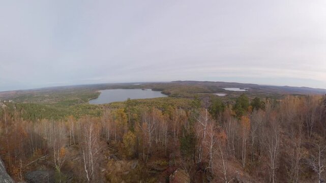 Picturesque rock massif in autumn. A granite ridge at the foot of which lies a pine-birch forest and lakes.