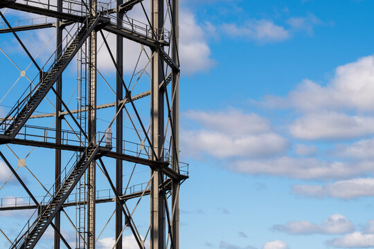 Industrial infrastructure features a steel structure with framework lattice tower engineering and construction against open sky for industry