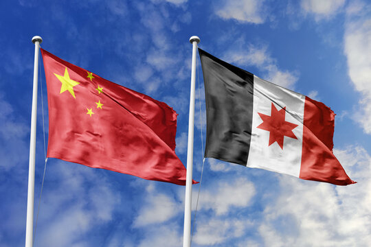 China and Udmurtia flags waving in a clear blue sky, symbolizing a powerful diplomacy, a strategic partnership, and a shared vision of unity for a sustainable future.